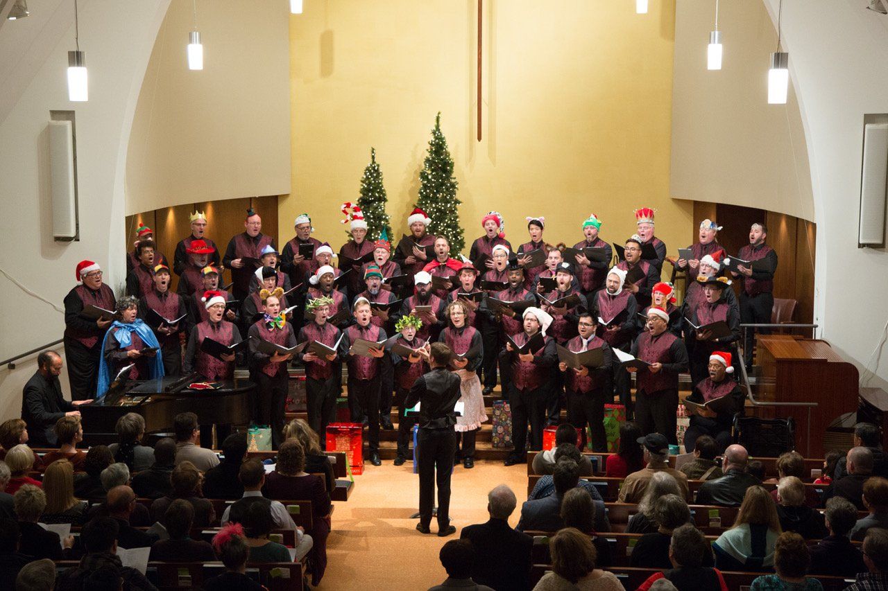 A choir is singing in front of a crowd in a church