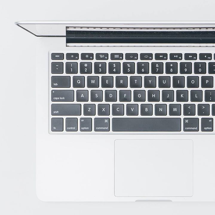 A close up of a laptop keyboard with a ruler on it