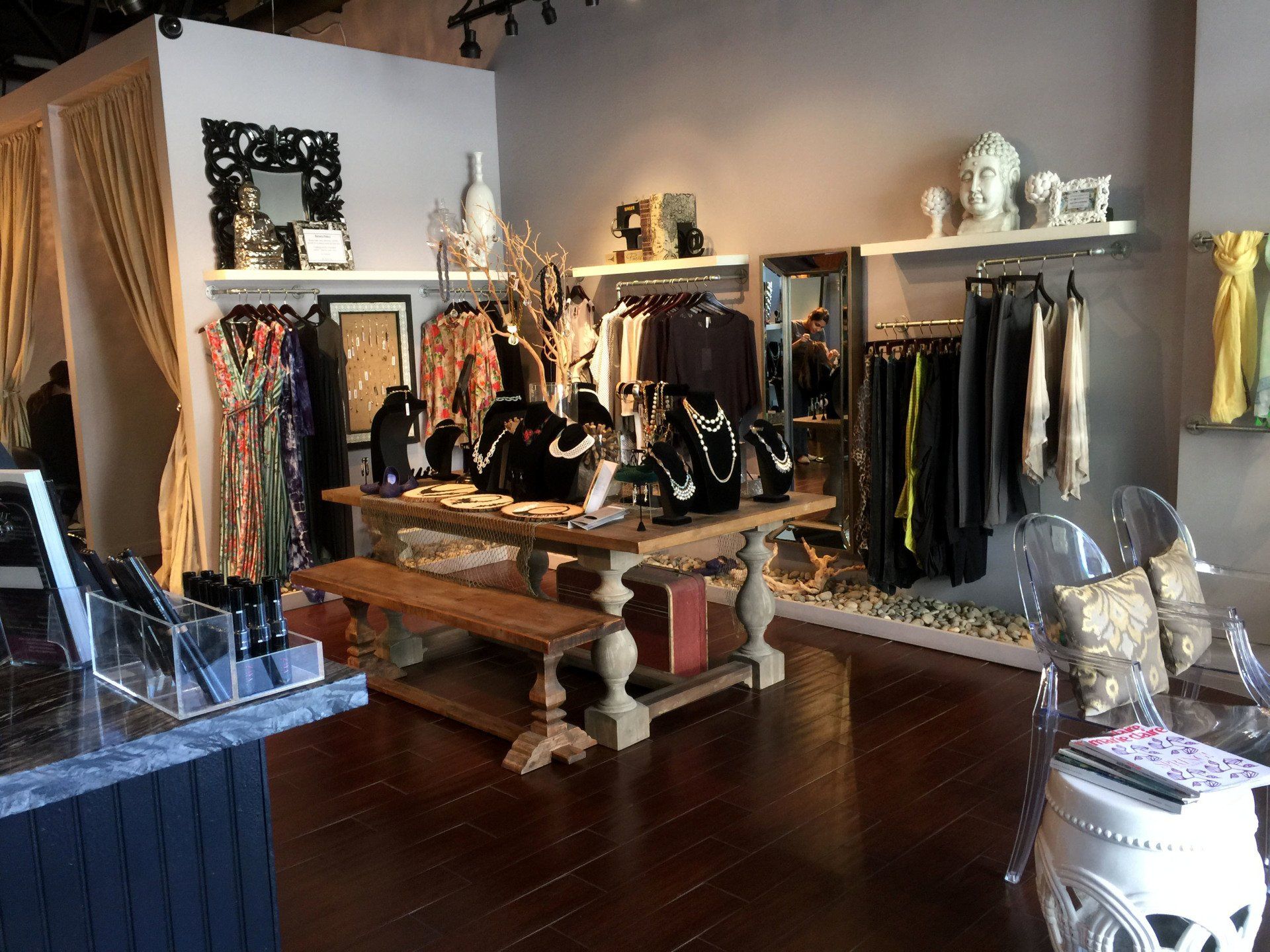 A store filled with lots of clothes and jewelry on display.