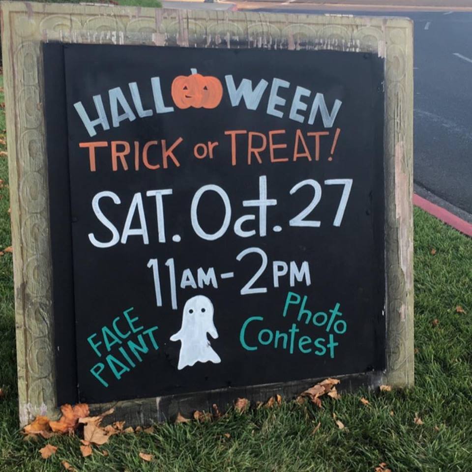 A sign that says halloween trick or treat on it