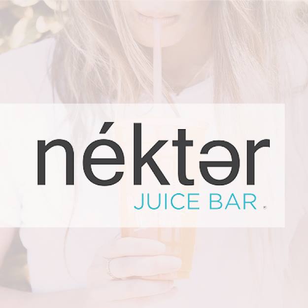 A woman is drinking a juice through a straw from a nekter juice bar