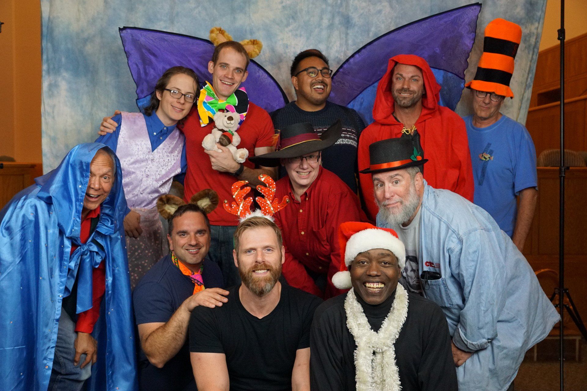 A group of people dressed in costumes are posing for a picture.