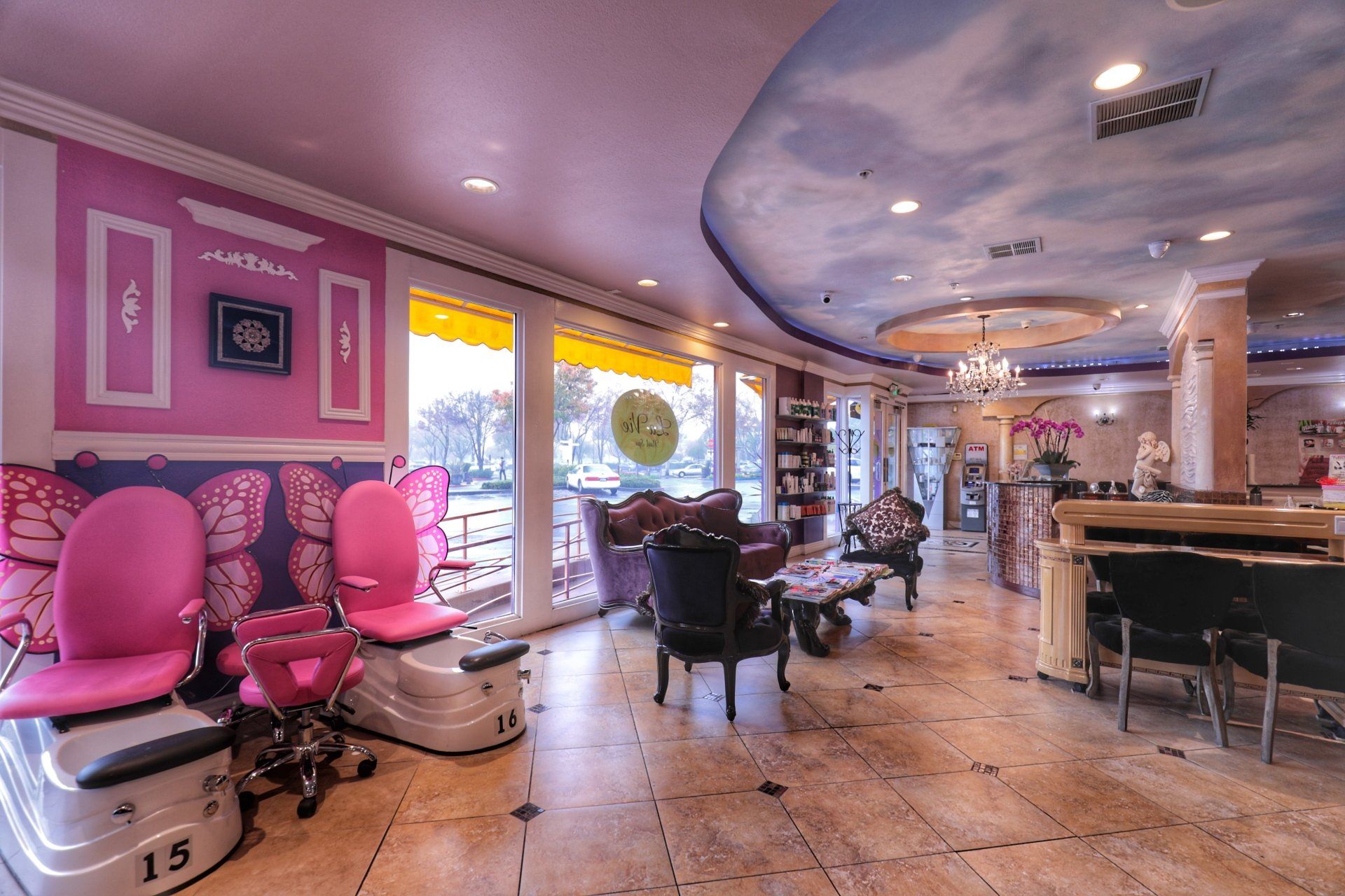 A salon with pink chairs and a blue ceiling