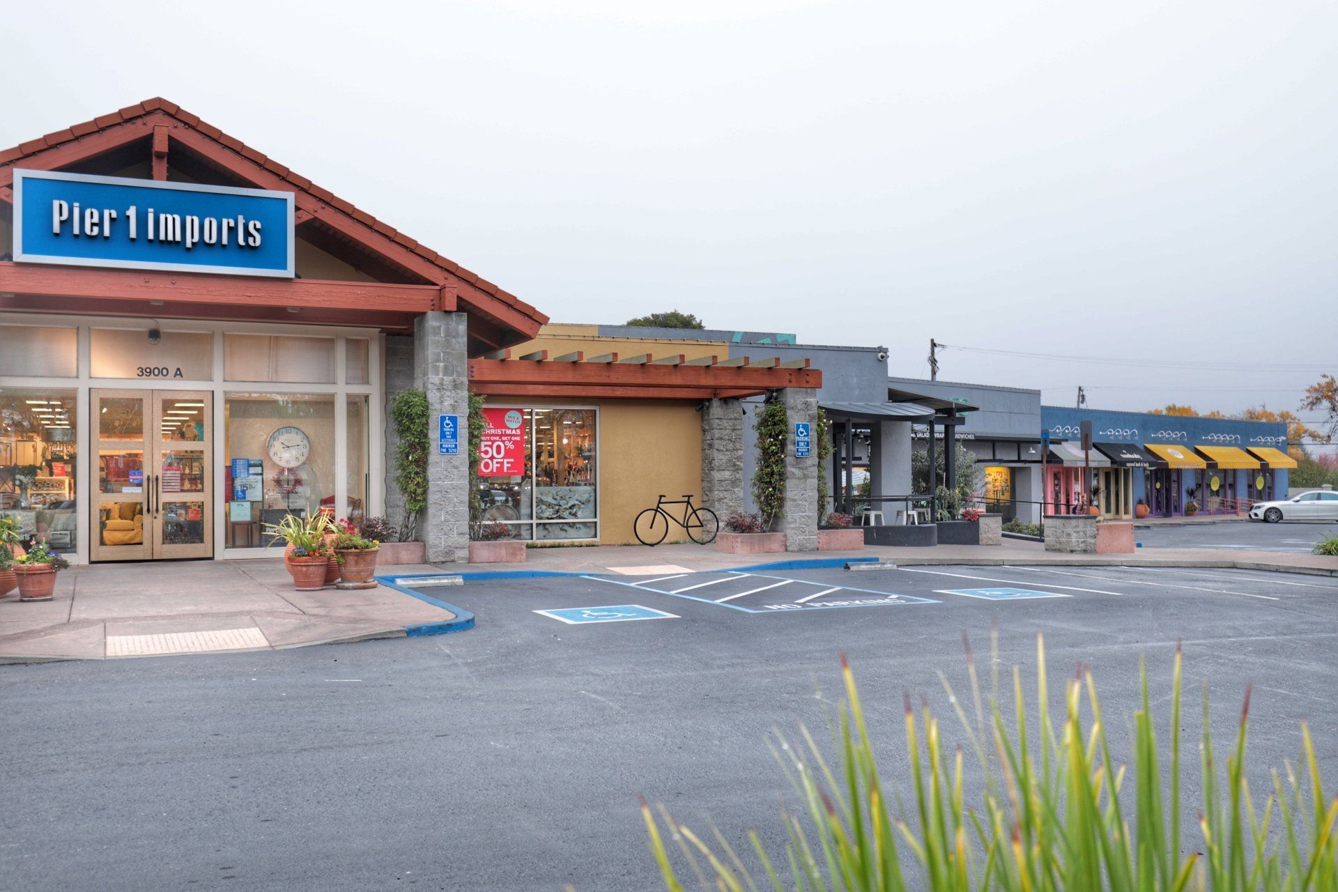 A pier 1 imports store is surrounded by other stores