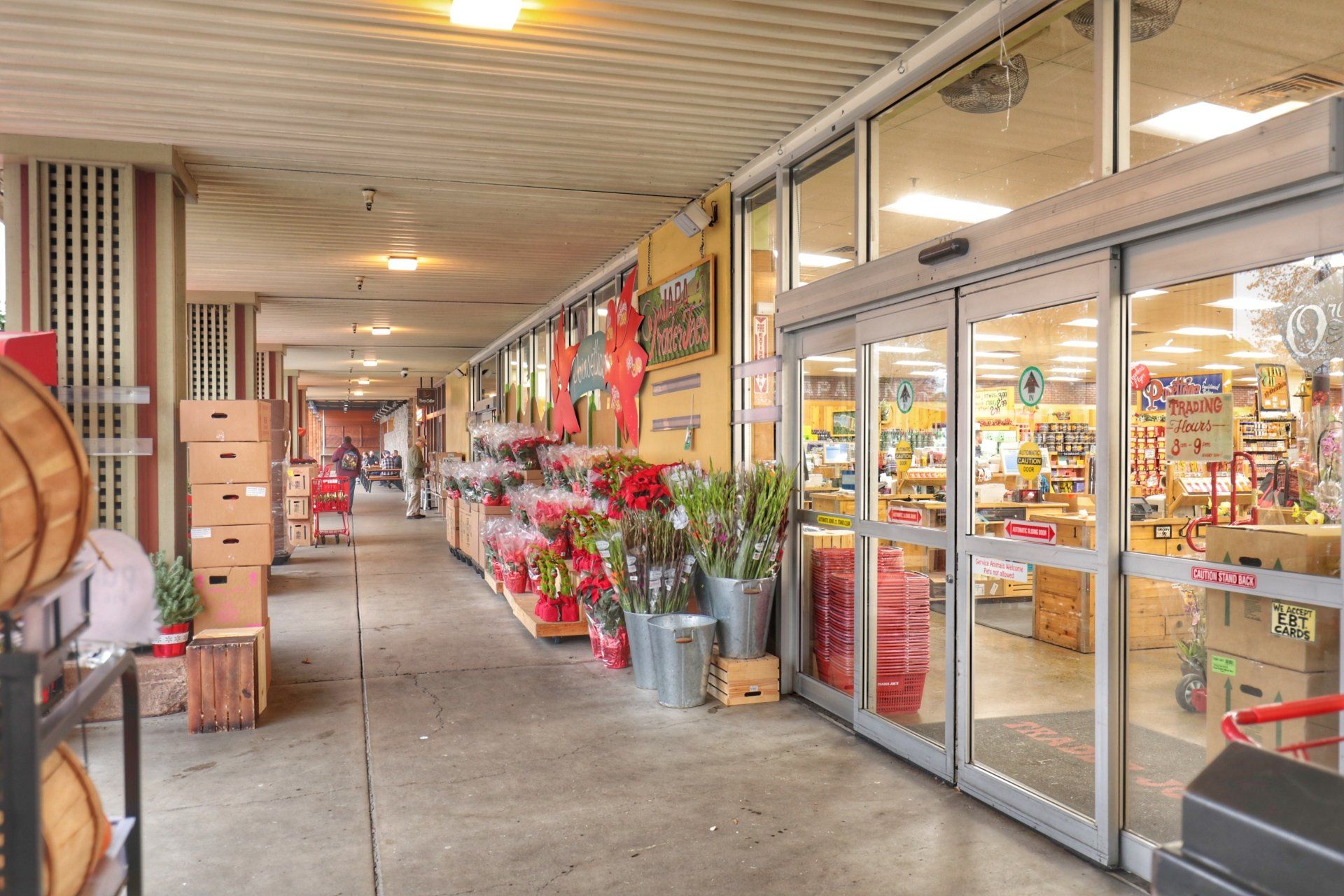The inside of a grocery store with sliding glass doors.