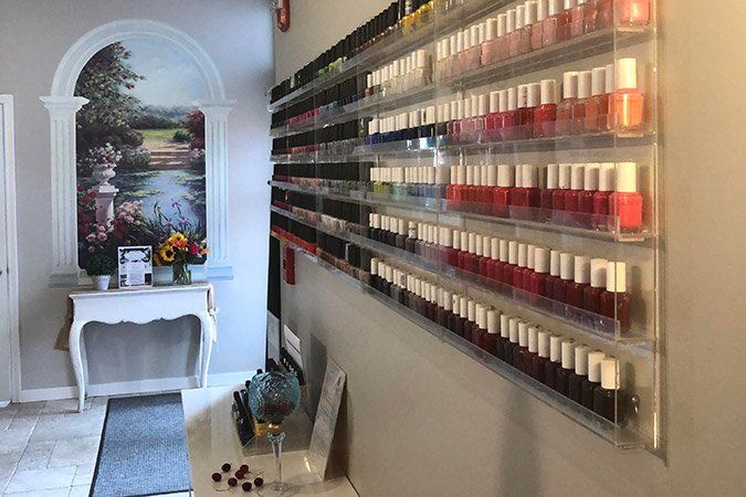 A room with a lot of nail polish on the wall.