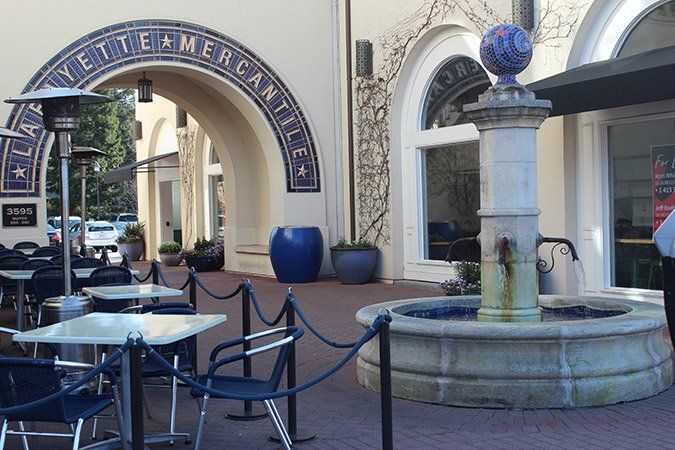 A fountain in front of a building that says welcome mercantile