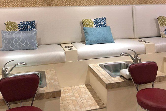 There are two chairs and a sink in the room.