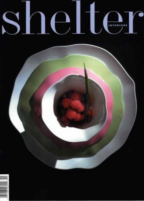 A magazine called shelter with a bowl of strawberries on the cover