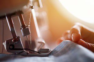 Tailor at Work on Sewing Machine.