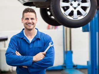 Mechanic smiling while holding tool - Auto Mechanic in Edinburgh, IN Mechanic smiling while holding tool - Auto Mechanic in Edinburgh, IN