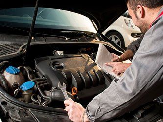 Auto Mechanic fixing a car - Auto Repair Shop in Edinburgh, IN Auto Mechanic fixing a car - Auto Repair Shop in Edinburgh, IN