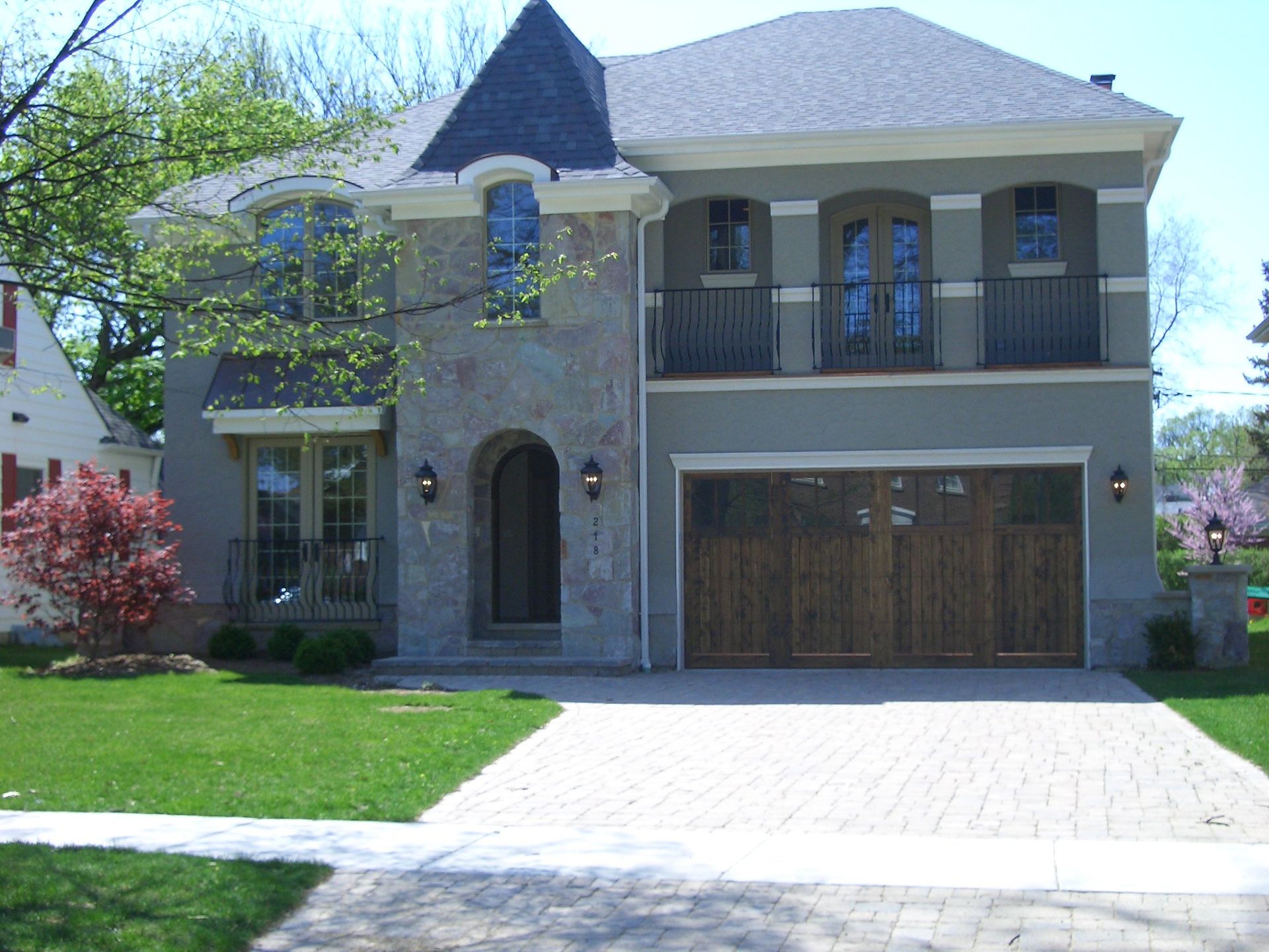 A large house with a wooden garage door