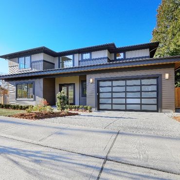 A large house with a large garage door and a lot of windows
