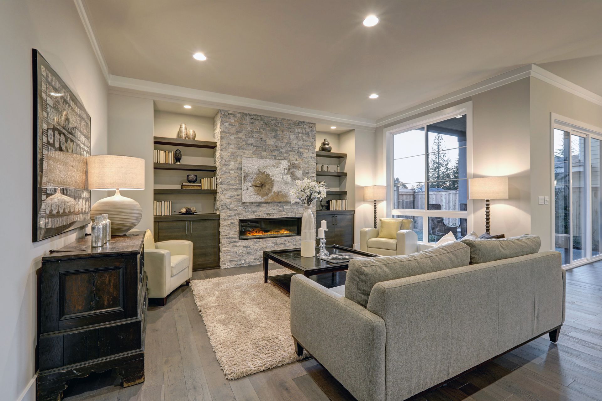 A living room with a couch , chairs , coffee table and fireplace.