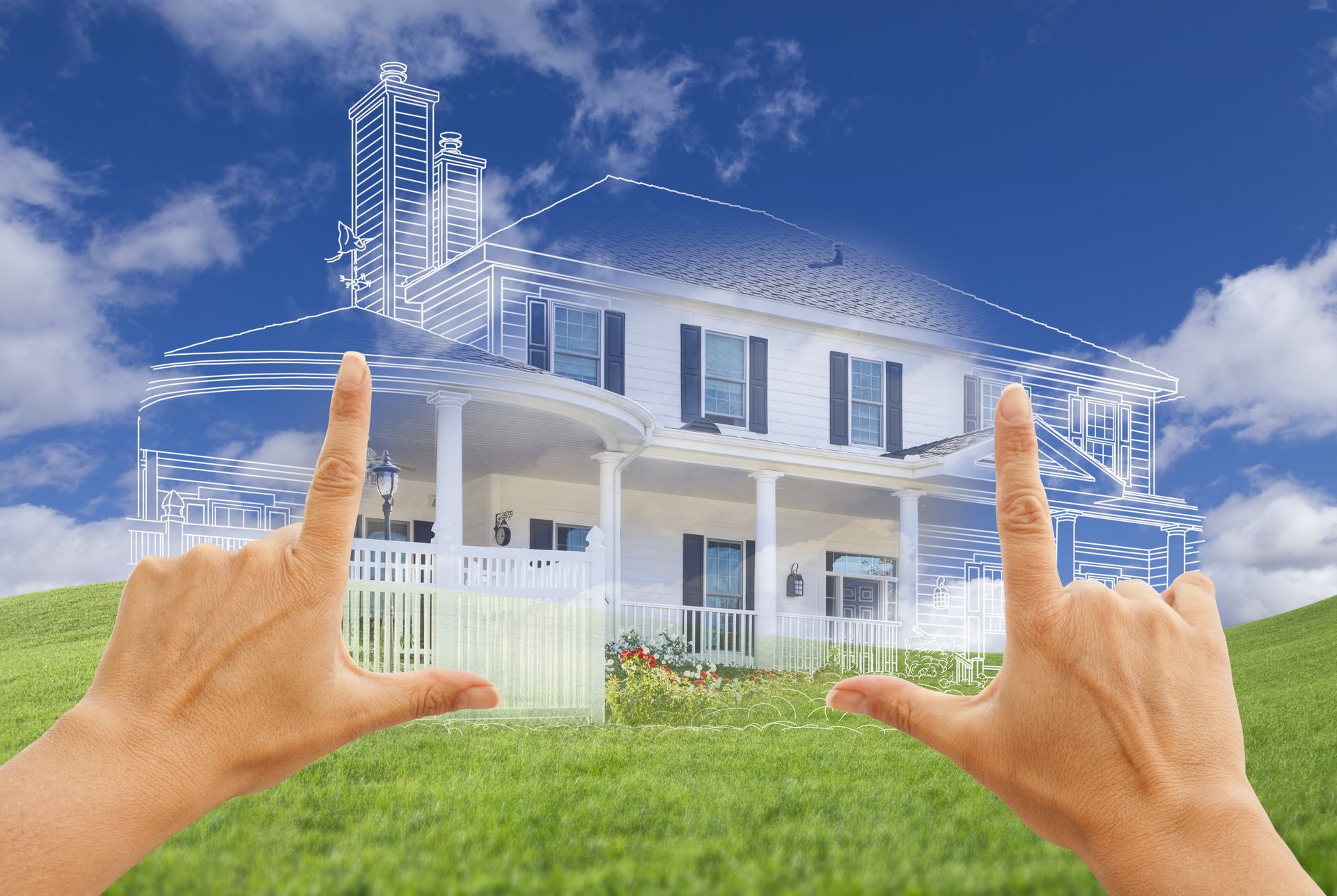A person is holding a drawing of a house in their hands