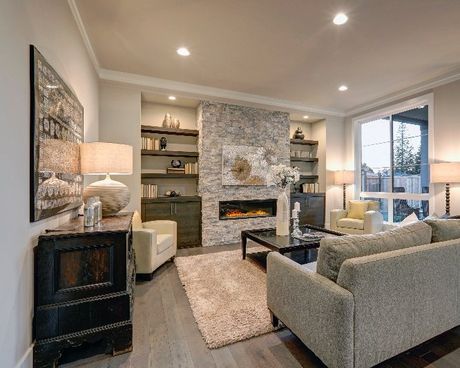 A living room with a couch , chairs , coffee table and fireplace.