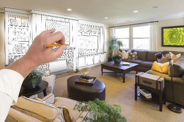 A person is drawing a living room with a pencil
