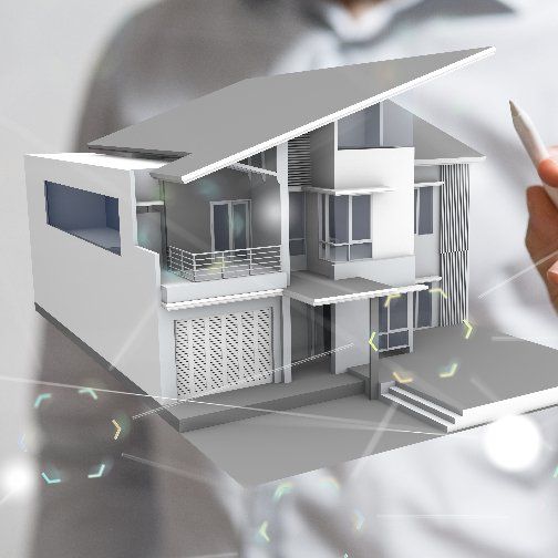 A man is holding a model of a house in his hand