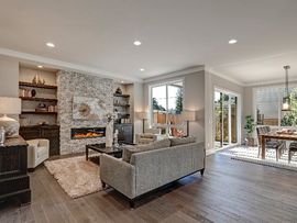 A living room filled with furniture and a fireplace in a new home.