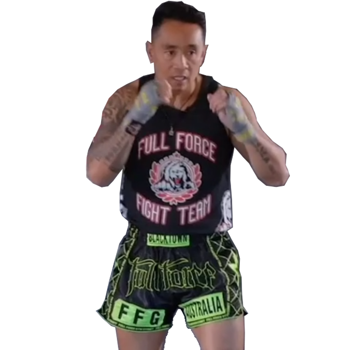 Boxer posing with fists up, wearing black and neon green fight shorts against a white background