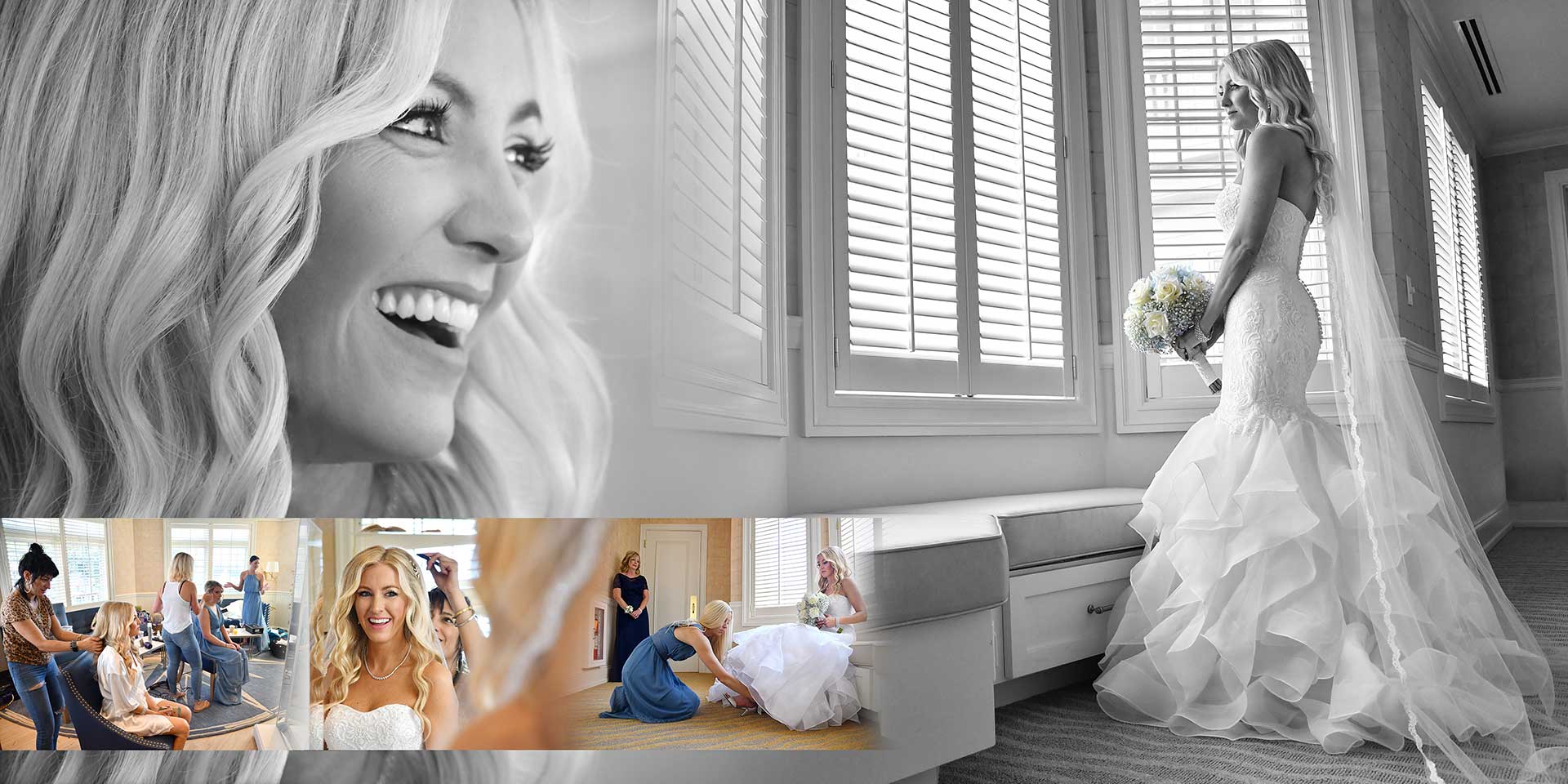 Bride in a white gown stands by a window, smiling in a black-and-white wedding portrait.