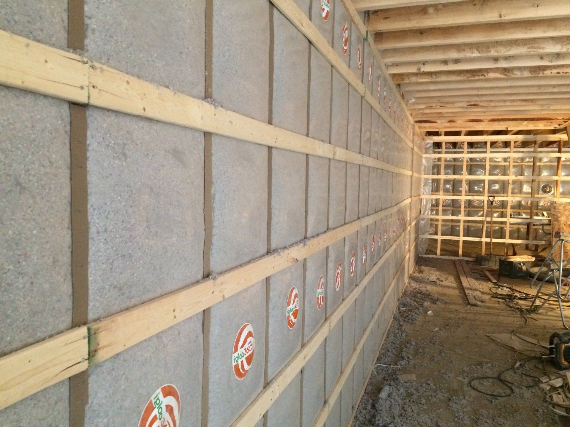 A wall with a lot of bricks and wooden beams