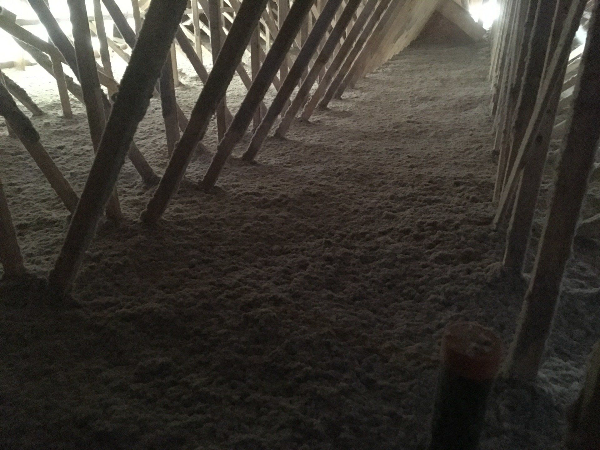 A dark room with a lot of wooden beams