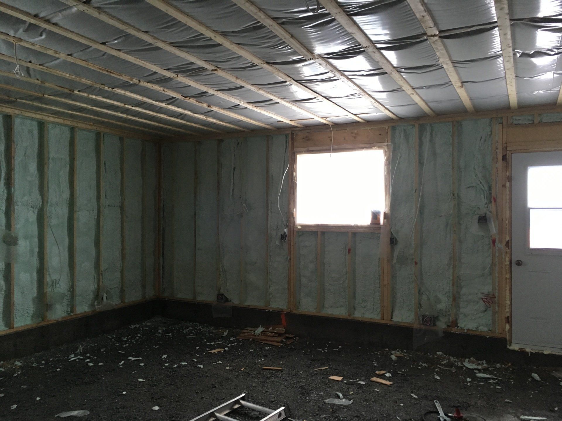 A room with a window and a ladder in it
