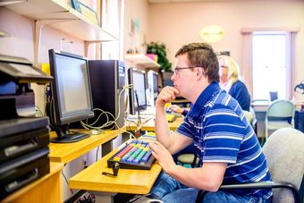 boy with down syndrome working on computer