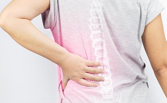 Woman In Pain Holding Her Back — Bethlehem, PA — Salib Oncology
