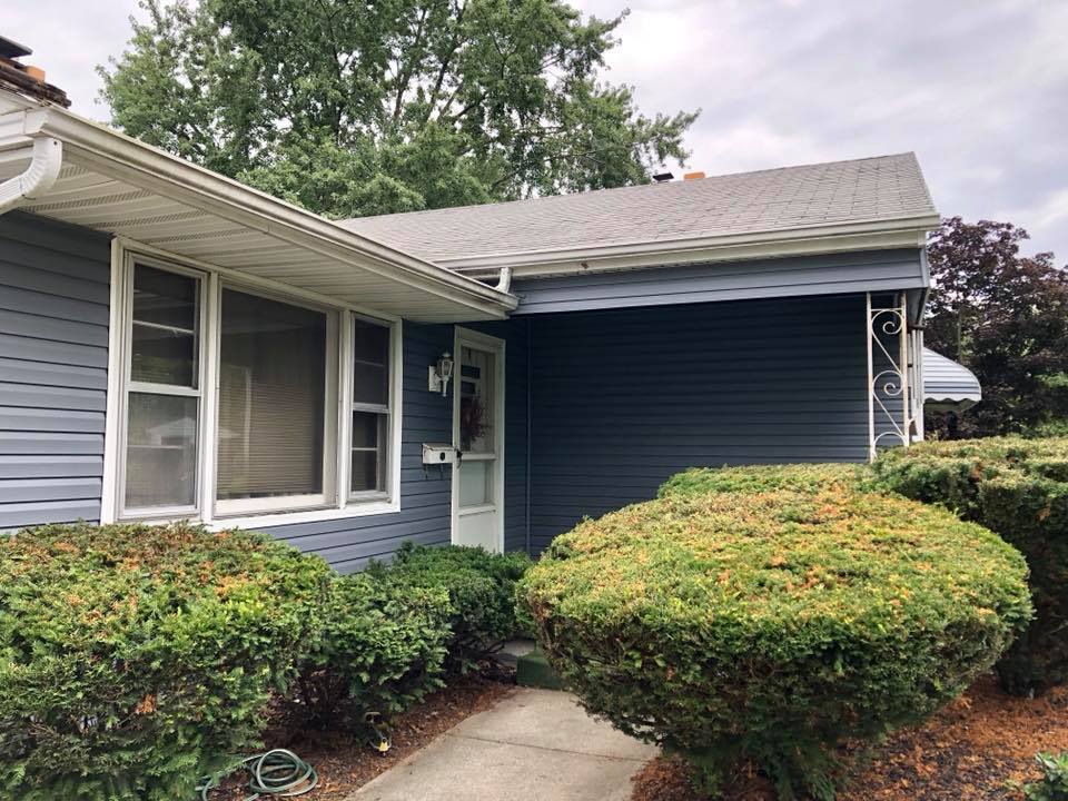 A blue house with a walkway leading to it
