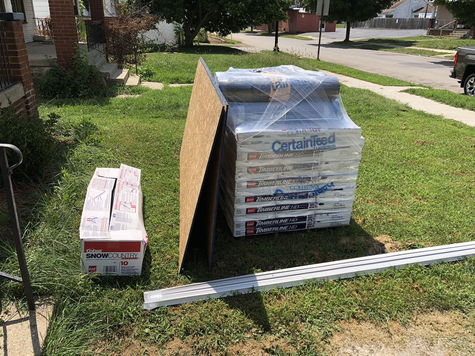 A stack of boxes sitting on top of a lush green lawn.