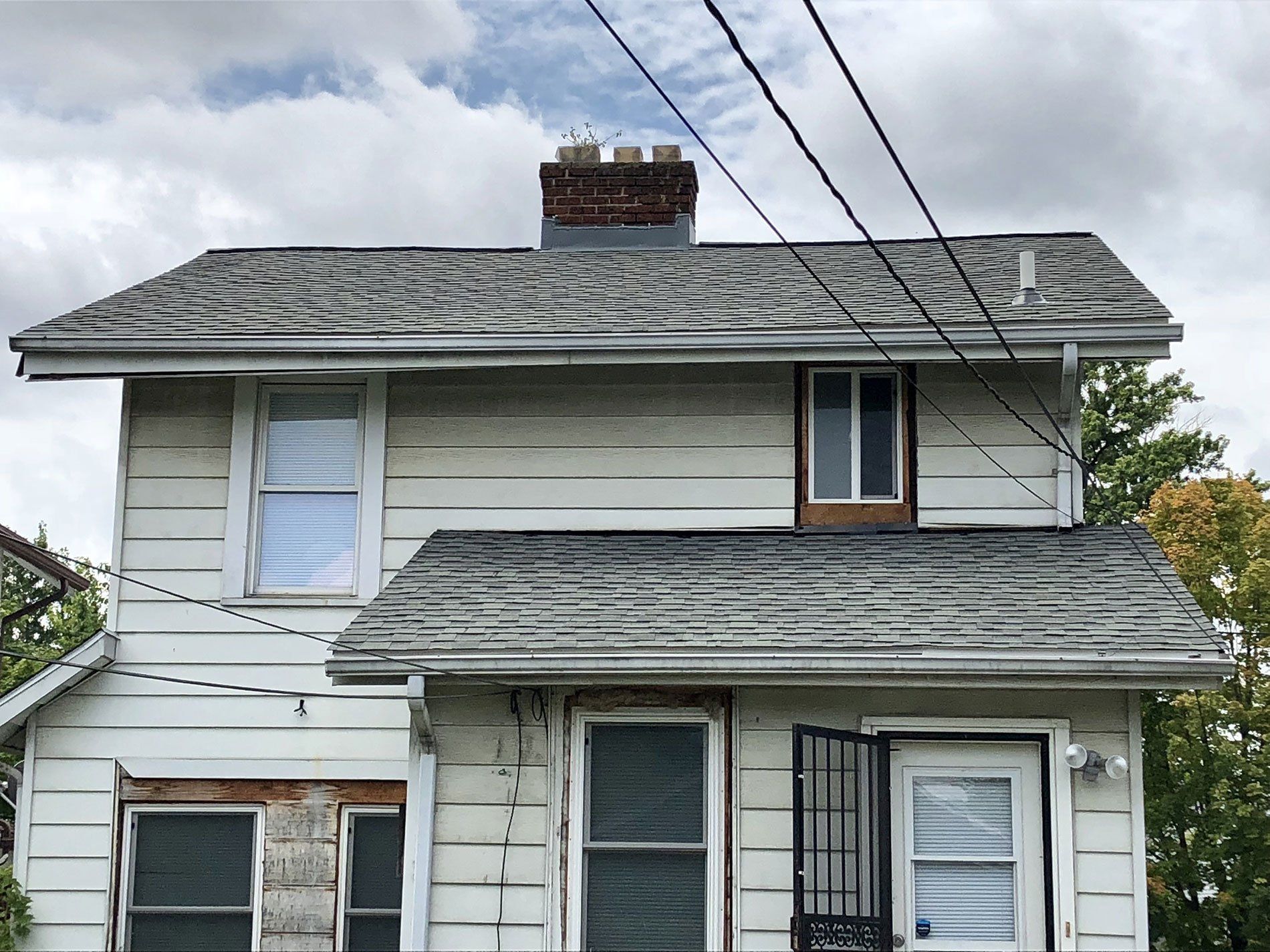 A white house with a chimney on top of it