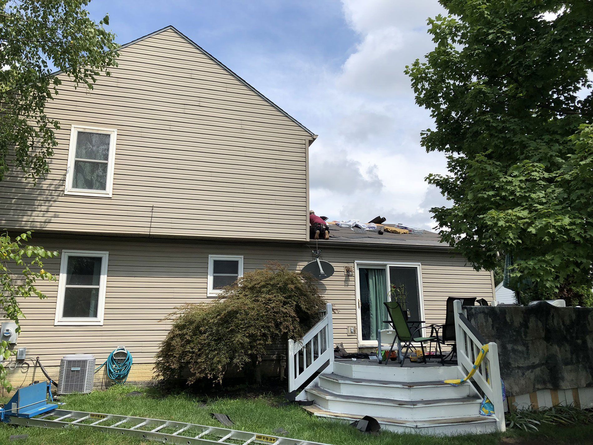 The back of a house with a deck and stairs.
