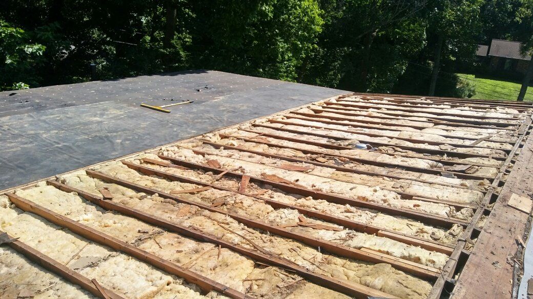 A close up of a roof with a lot of wood on it.