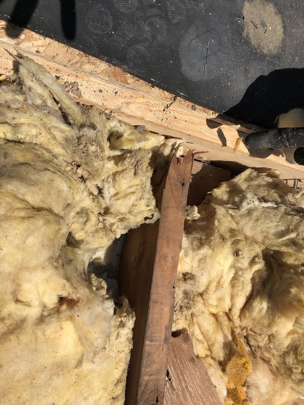 A close up of a piece of wood with a piece of insulation on it.