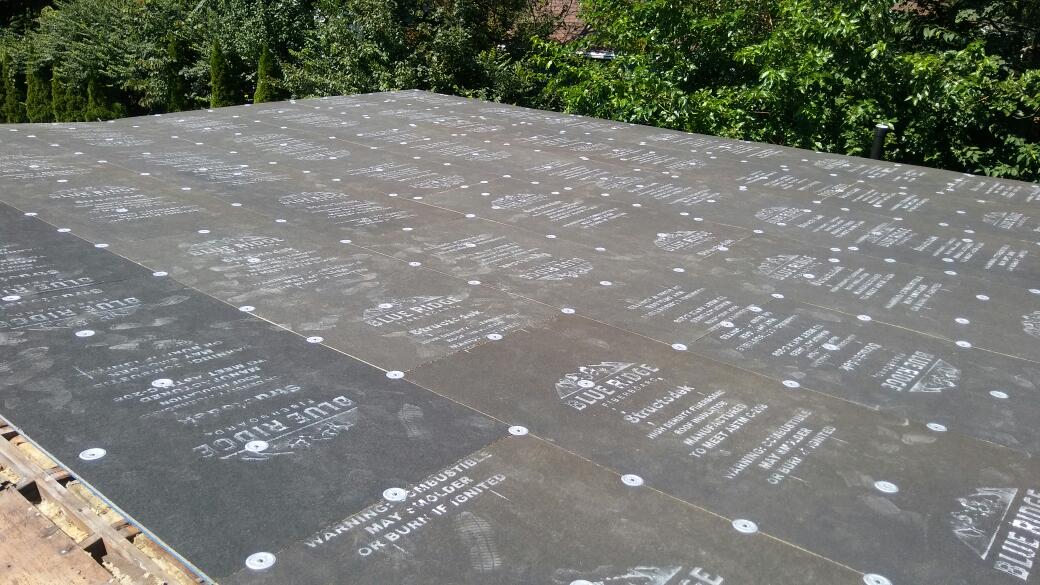 A roof with a lot of holes in it and trees in the background.