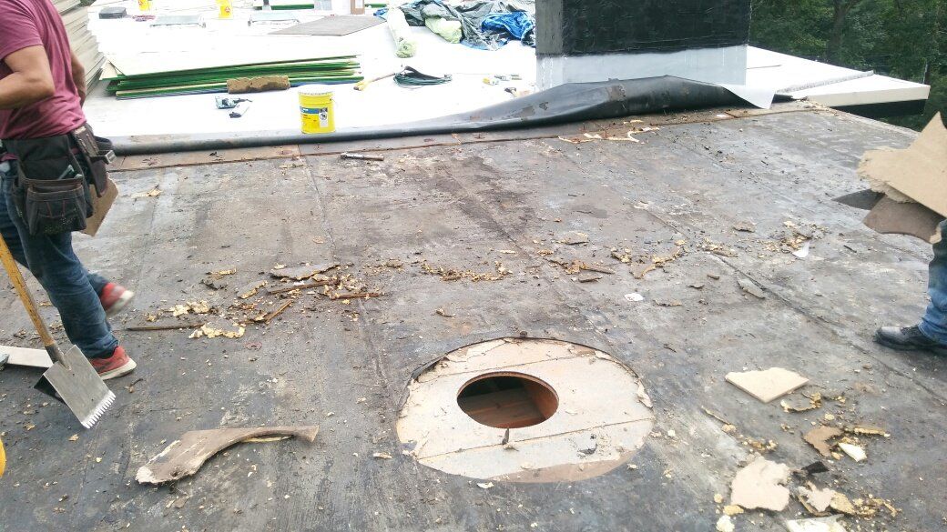 A man is standing next to a hole in the ground.