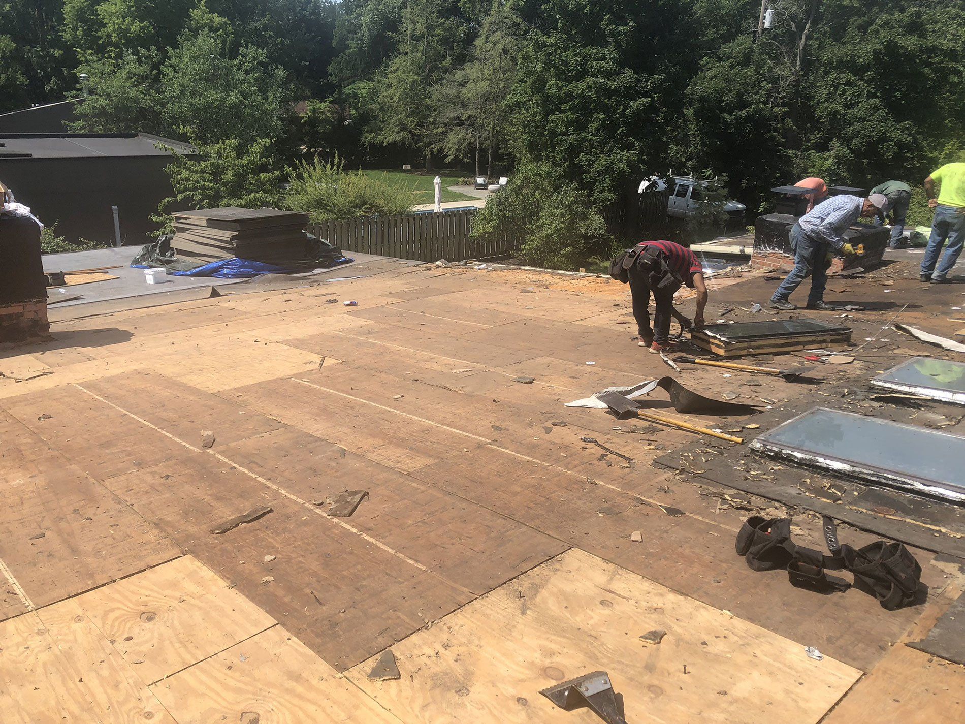 A group of people are working on a roof.