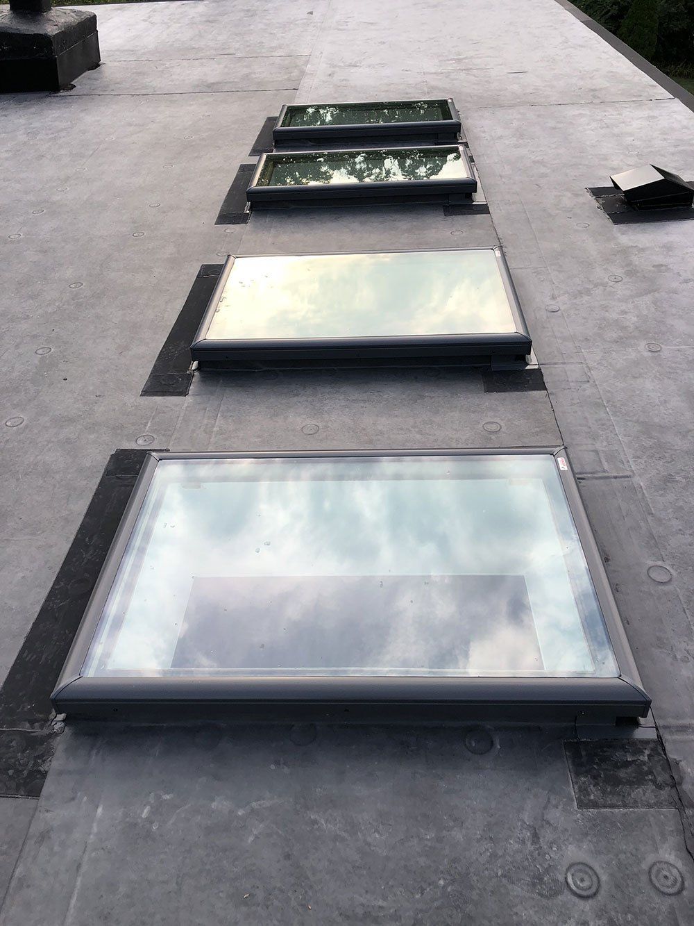 There are three skylights on the roof of a building.