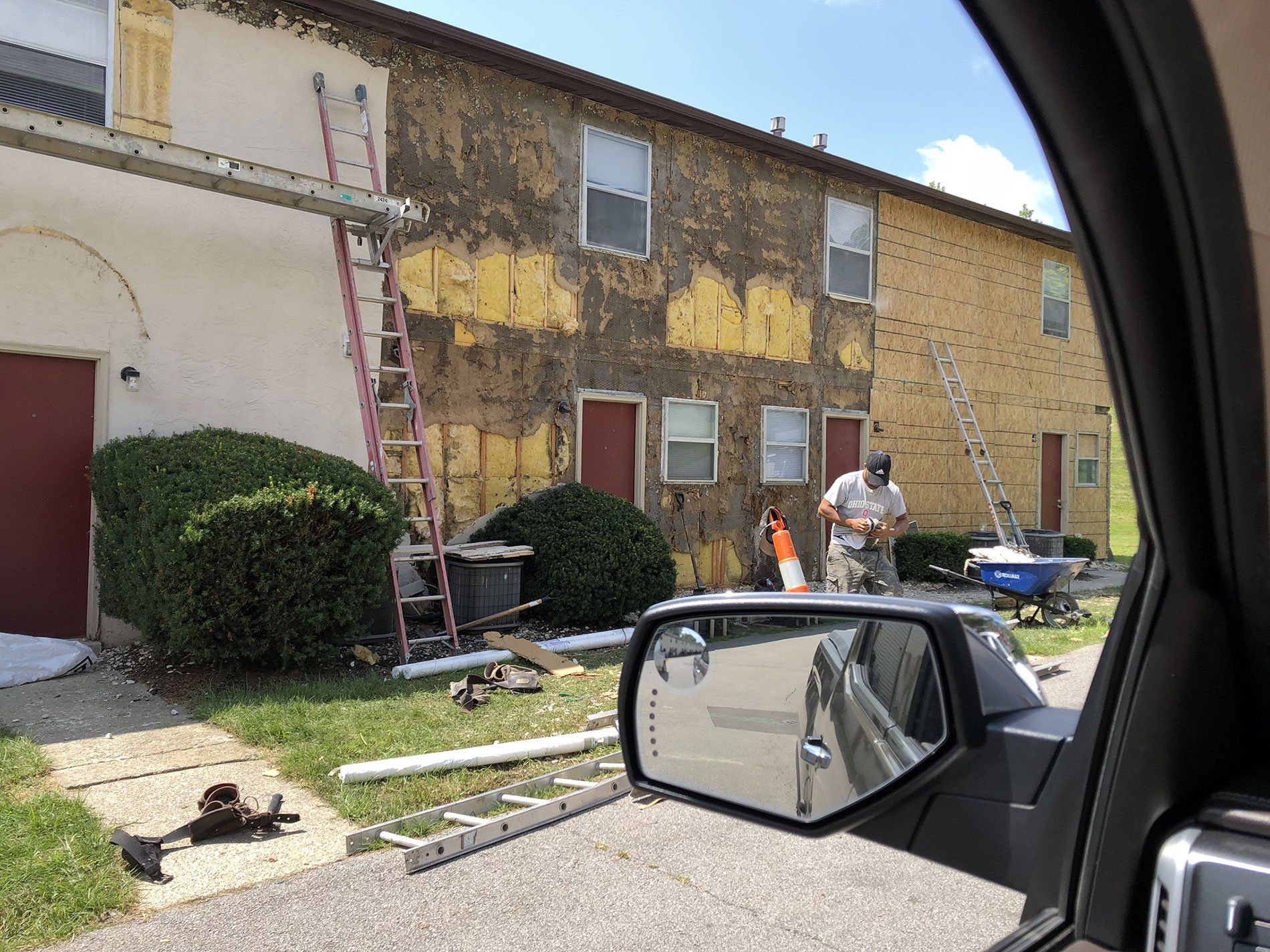 A man is painting the side of a building.