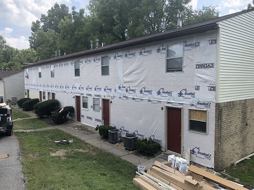 A building with a lot of windows and doors is being remodeled.