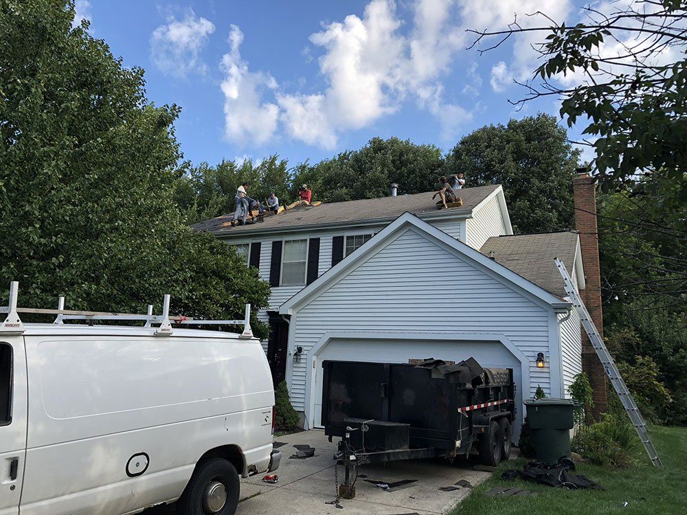 A white van is parked in front of a house.