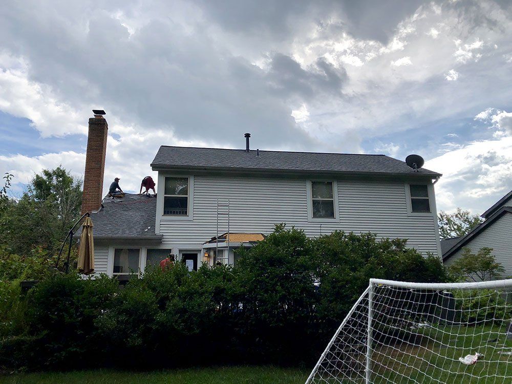 A white house with a soccer goal in front of it.