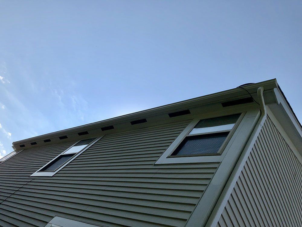 Looking up at a house with a blue sky in the background.