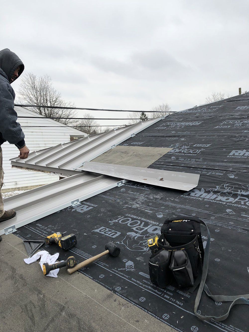 A man is working on the roof of a building.