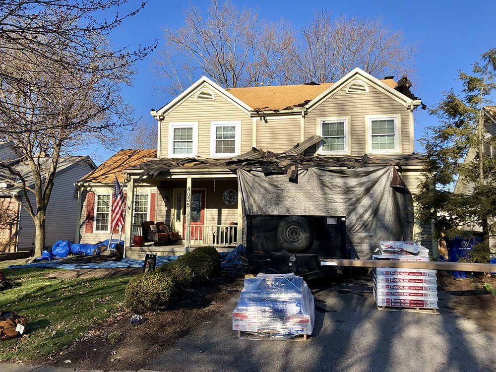 A house is being remodeled with a new roof.