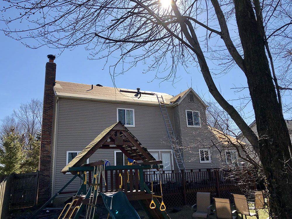 A house with a playground in front of it.