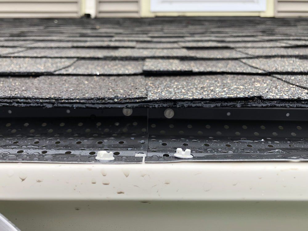 A close up of a roof with a gutter on it.